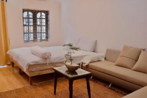 a living room with a couch and a table at KUHA home in Nha Trang
