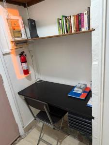 a black desk in a room with a book shelf at Brise Marine Sxm in Marigot