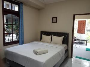 a bedroom with a bed with a bag on it at Pakemsari Resort Hotel in Pakem
