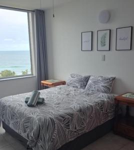 a bedroom with a bed with a view of the ocean at Peacehaven's Finest View 107 in Scottburgh