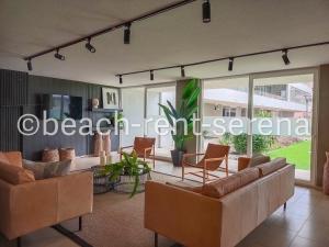 a living room with couches and chairs at Beach Rent La Serena in La Serena