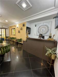 a lobby with a waiting area with green chairs at Nsenou Tower in Yaoundé