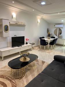 a living room with a couch and a table at Nsenou Tower in Yaoundé