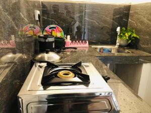 a stove top oven sitting in a kitchen at Linu Homestay in Hiriketiya