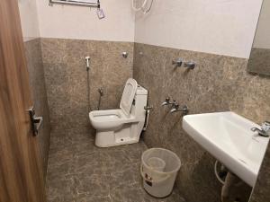 a bathroom with a toilet and a sink at Hotel GT Galaxy in Chennai