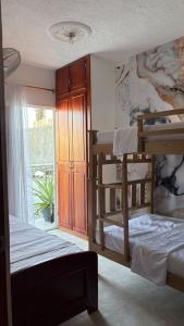 een slaapkamer met twee stapelbedden en een raam bij Amanecer Costero in Santa Marta