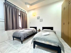 En eller flere senge i et værelse på Simee Cozy Homestay ,Simee, Ipoh Town