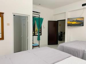 Postel nebo postele na pokoji v ubytování Hotel Sala 4 Malioboro