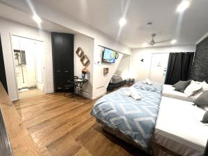 a bedroom with two beds and a table in it at Aqua Blue Motel in Gold Coast