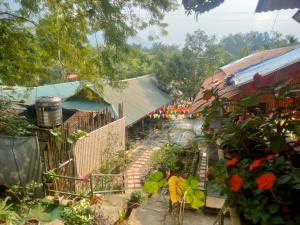 a garden with flowers and plants and a building at ha giang loop & tour in Bản Kin