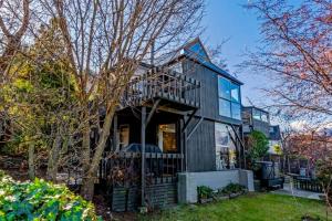 une maison noire avec un toit en gambrel dans l'établissement Panoramic Farmhouse theme with shared spa pool, à Queenstown