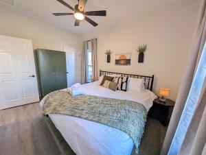 a bedroom with a large bed with a ceiling fan at Modern Norwalk Retreat 2 King Suites Sunroom in Norwalk