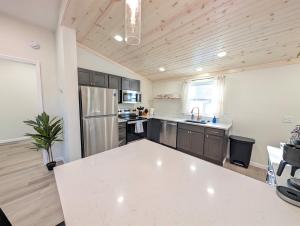 a kitchen with a white counter top in a room at Modern Norwalk Retreat 2 King Suites Sunroom in Norwalk +13 photos