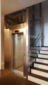 a elevator in a building with a stair case at Appartements Krautgasser in San Candido