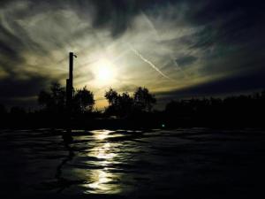 a sunset with the sun in a cloudy sky at Huge Holiday Home in Marina di Castagneto Carducci near Sea in Donoratico +32 photos