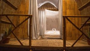 a room with a bed in a room with a window at EL-NARA SEASIDE Beach Resort in El Nido