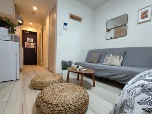 a living room with a couch and a table at ティエラ北池袋 in Tokyo