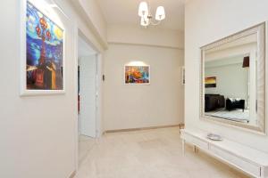 a hallway with a large mirror and a living room at Oksana's Bernadette Apartment in Rome