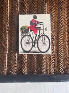ein Bild einer Frau, die Fahrrad fährt in der Unterkunft Kibwana Beach Bungalows & Diving in Matemwe + 65 Fotos