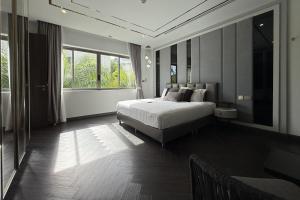 a bedroom with a bed and a large window at Villa Lion Phuket in Phuket +24 photos