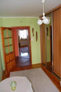 a room with a door and a room with a cross on the wall at Apartament Rodzinny w Kaliszu in Kalisz