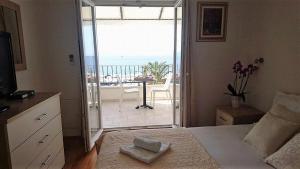 a bedroom with a bed and a view of a balcony at Apartment Vanja in Tučepi