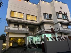 a large white building with lights on it at Hotel ODC Residency in Jowai