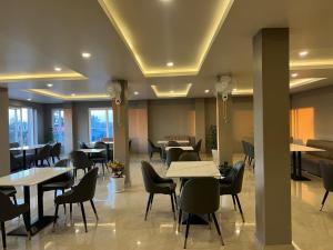 a dining room with tables and chairs in a restaurant at Hotel ODC Residency in Jowai