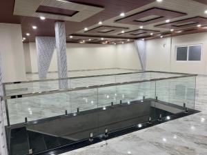 an empty room with a large glass wall at Hotel ODC Residency in Jowai