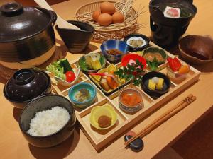 a tray of food with rice and other dishes on a table at SPA&HOTEL RESORT Furano La Terre in Nakafurano
