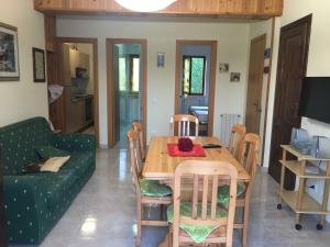 a living room with a wooden table and chairs at Sangro Apartment in Castel di Sangro