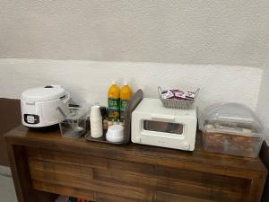 a microwave sitting on top of a wooden table at Haemil Stay in Daegu