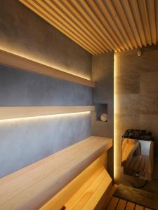 a sauna with a wooden bench in a room at KONA RESORT AWAJI KAI in Awaji