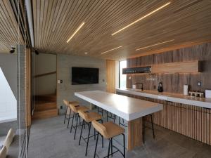 a kitchen with a large white table and chairs at KONA RESORT AWAJI KAI in Awaji