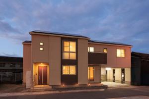 a large brick house with its lights on at Triangle 2nd in Beppu
