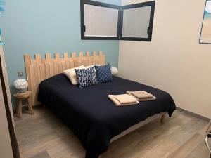 a bedroom with a bed with two towels on it at Schlof'zheim in Friesenheim