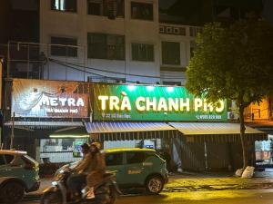 a group of people riding a motorcycle down a street at night at Hoa Hồng 301MD in Hanoi