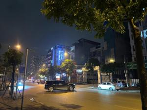 a car driving down a city street at night at Hoa Hồng 301MD in Hanoi