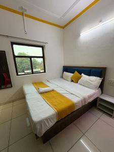 a bedroom with a large bed with a window at AD ressidency Hotel in Agra