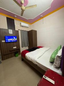 a bedroom with a bed and a tv in it at AD ressidency Hotel in Agra
