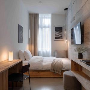 a bedroom with a bed and a desk with a chair at rõõm collective in Odiongan