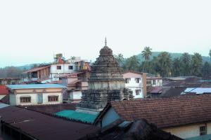 een uitzicht op een pagode in een stad met gebouwen bij Aisiri Guest House in Gokarna +14 foto's