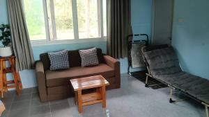 un salon avec un canapé et une table basse dans l'établissement Mor Aud Sriboya Home 2, à Ko Siboya