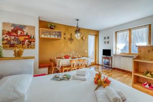 a living room with a table and a dining room at Appartamento Big Lem - Happy Rentals in Sauze d'Oulx