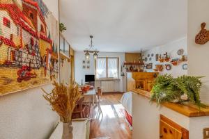 a kitchen and living room with a dining room at Appartamento Big Lem - Happy Rentals in Sauze d'Oulx