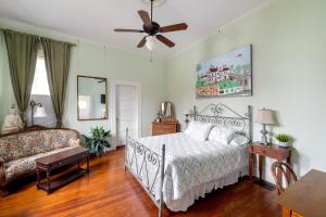 a bedroom with a bed and a ceiling fan at Heights Ironworks Bed & Breakfast in Houston