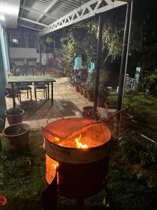 a large pot with a fire in a yard at Sparrow valley in Coonoor