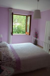 a bedroom with a large bed and a window at La Sorgente B&B in Cetara