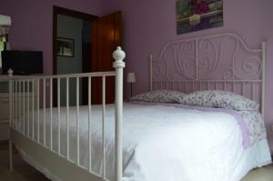 A bed or beds in a room at La Sorgente B&B