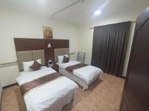 En eller flere senge i et værelse på العييري للشقق المخدومة الاحساء 4